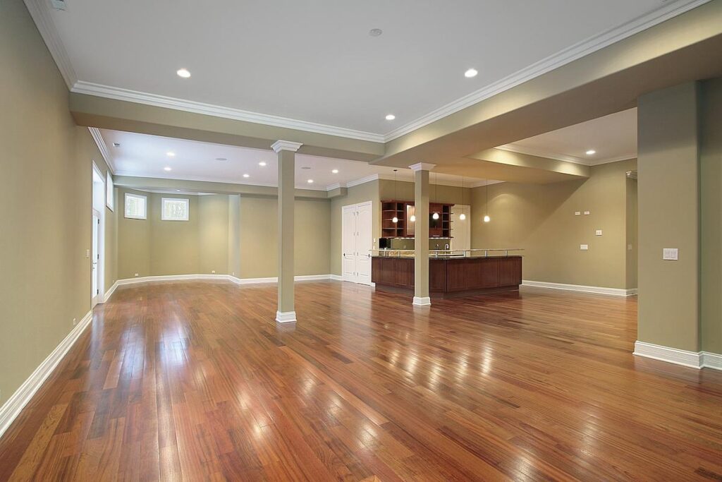 A basement with a shiny hardwood floor
